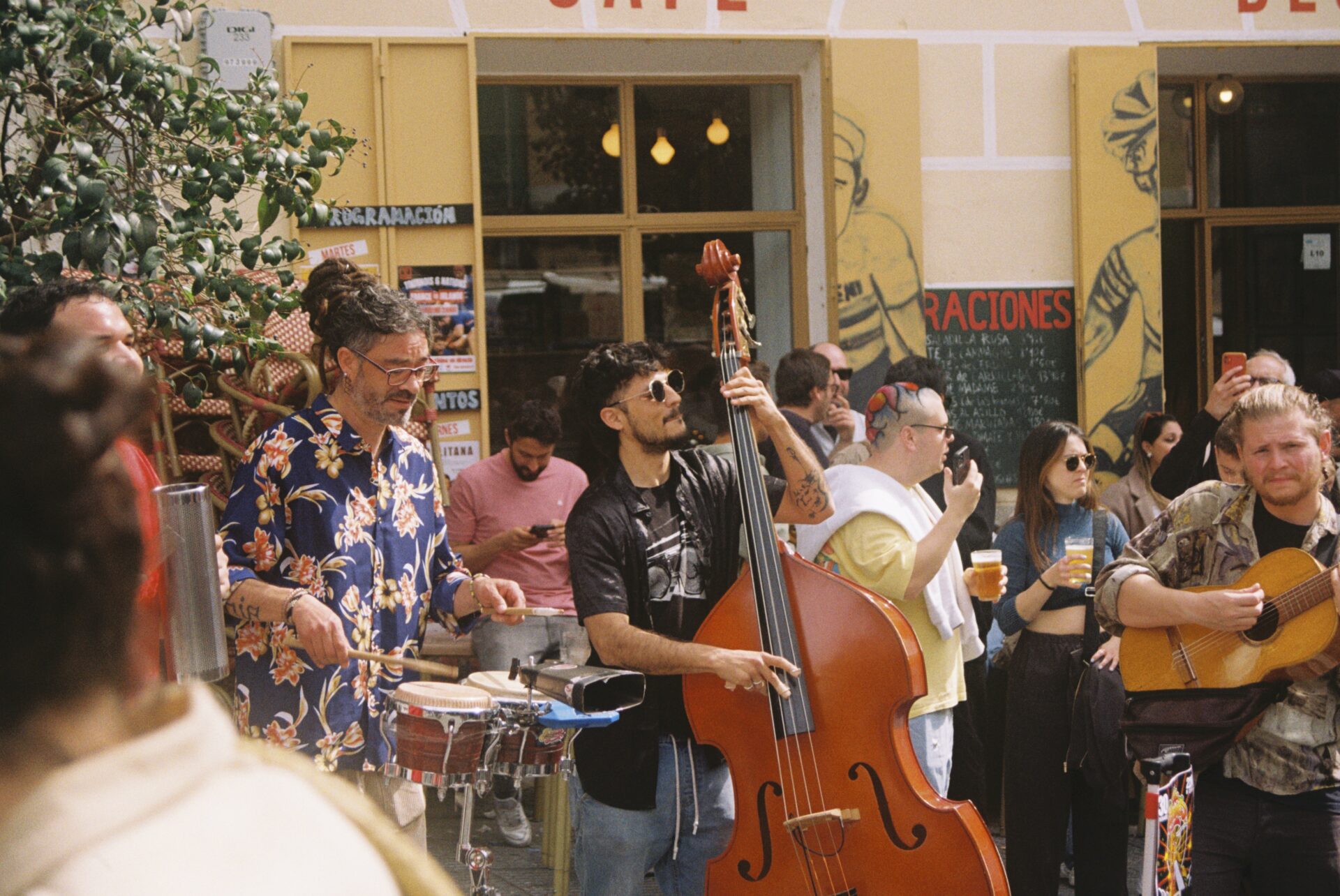 A group of musicians perform in a bustling town square