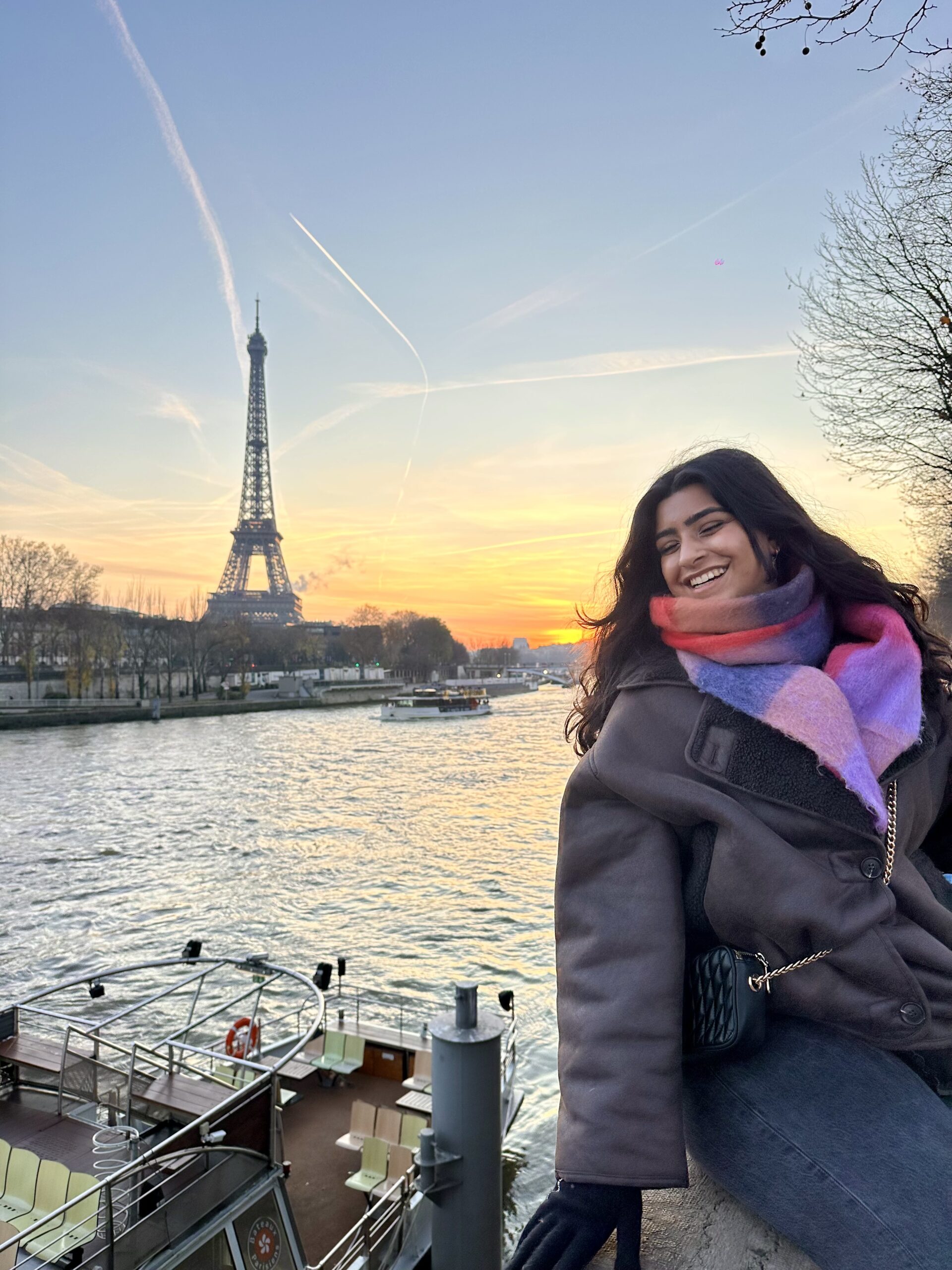 A student takes a selfie in front of the Eifel Tower