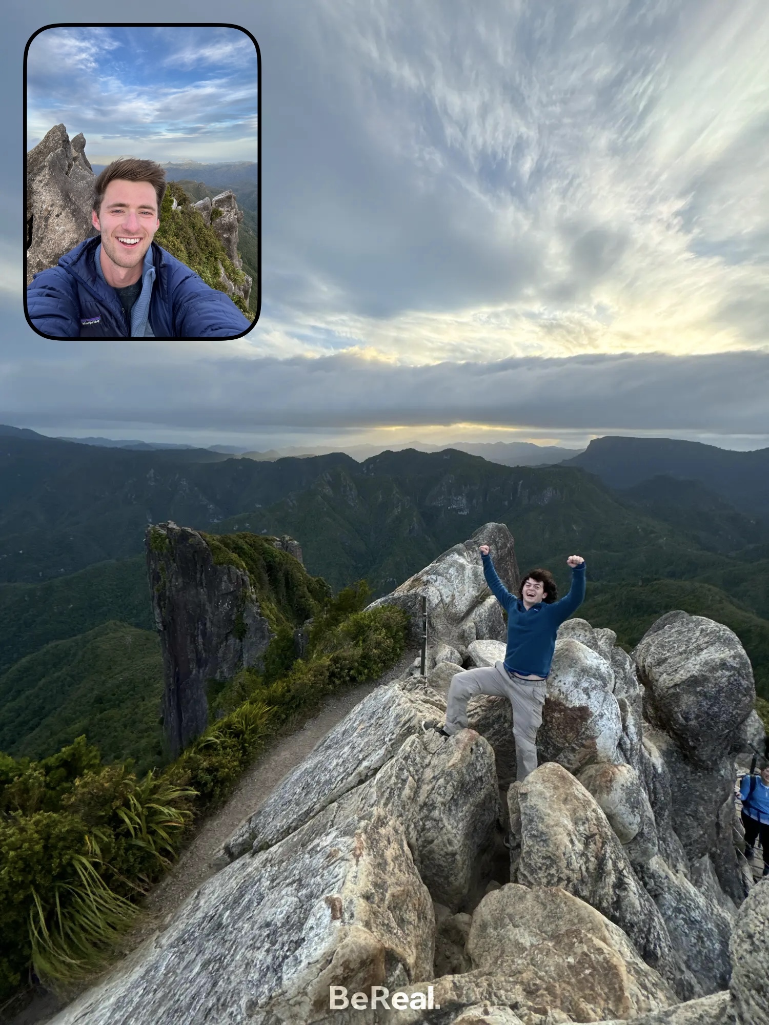 A student posting a Be Real photo in front of a mountain range while hiking