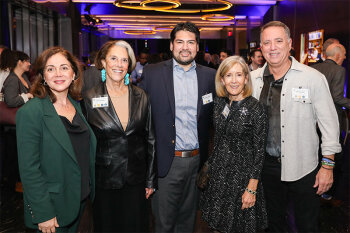 Group posing for photo at reception event