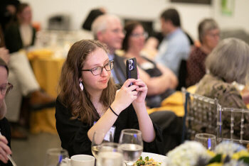 woman taking photo with her phone