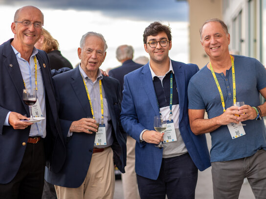 4 guys smiling and posing for the camera