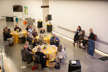 overview image of people mingling at tables