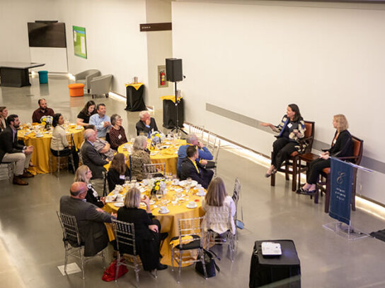 overview image of people mingling at tables