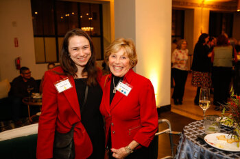 Two female attendees pose for a photo at the George Eastman Circle Annual Member Dinner.