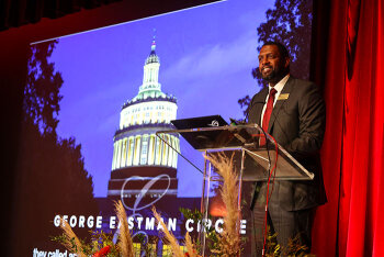 A guest speaker on stage presenting