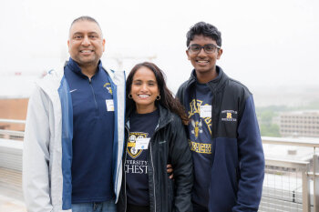 A family of three pose for a photo at the George Eastman Circle Family Celebration, held April 30, 2023, within Washington, DC.