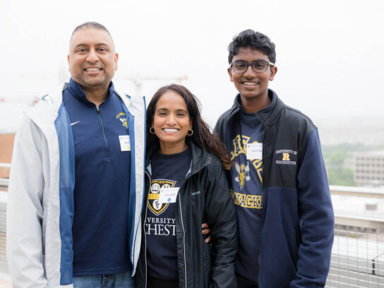 A family of three pose for a photo at the George Eastman Circle Family Celebration, held April 30, 2023, within Washington, DC.