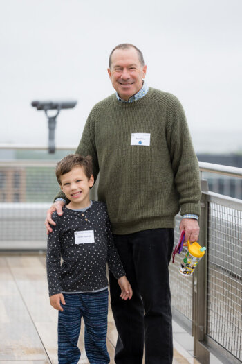 A man and child pose for a photo at the George Eastman Circle Family Celebration, held April 30, 2023, within Washington, DC.