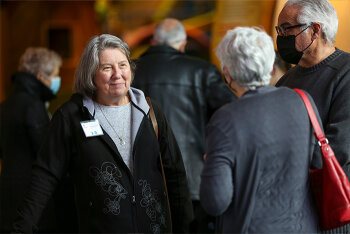 2 women speaking with each other