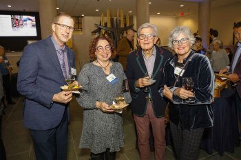 Group photo of 4 people posing for the camera