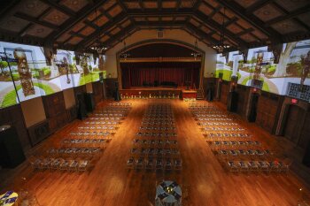 Aerial view of the MAG auditorium with screen projections on the side