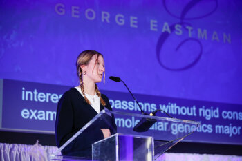 A young female giving a speech at the George Eastman Circle Annual Member Dinner.