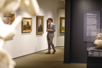 man in suite looking at an exhibit in the MAG