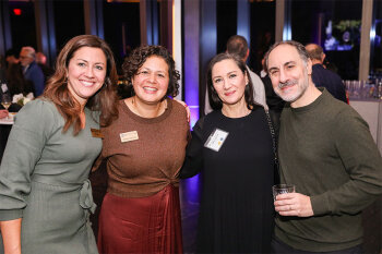 Group posing for photo at reception event