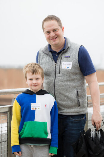 A man poses with his son at the George Eastman Circle Family Celebration, held April 30, 2023, within Washington, DC.