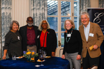 Three women and two men pose for a photo at the George Eastman Circle Faculty & Staff Reception held on March 30, 2023 within Rochester New York.
