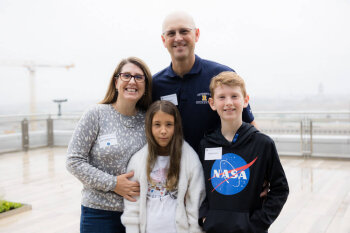 A family of four pose for a photo at the George Eastman Circle Family Celebration, held April 30, 2023, within Washington, DC.