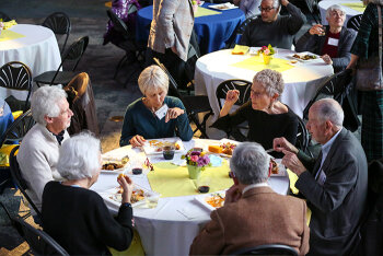 People sitting and eating at a round table