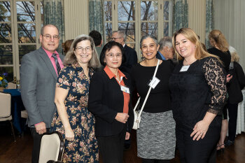 Five individuals posing for a photo.
