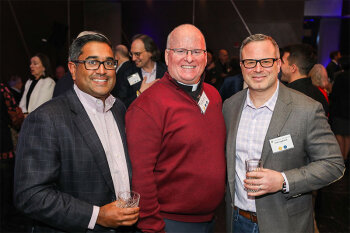 Group posing for photo at reception event