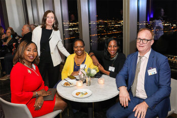 Group posing for photo at reception event