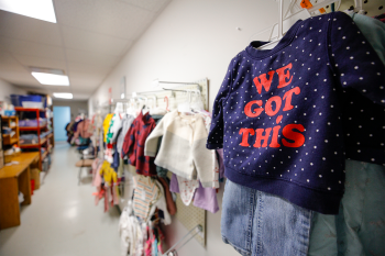 photo of clothing hung against a wall in a shop