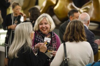 Candid photo of 3 women having a convsation