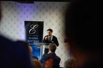 A student representative speaks at the podium during the George Eastman Circle Faculty & Staff Reception on March 19, 2025.