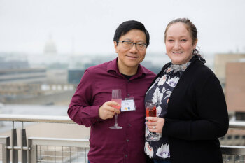 A man and woman pose for a photo at the George Eastman Circle Family Celebration, held April 30, 2023, within Washington, DC.