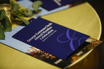 Pamphlet that say George Eastman Circle Annual Member Celebration on a table