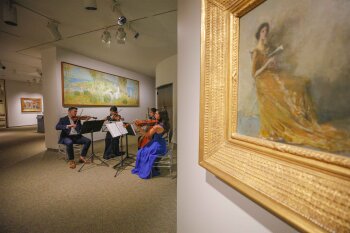 Orchestral quartet performing in an exhibit at the MAG