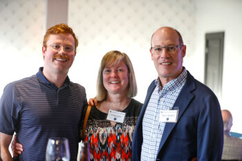 Three guests pose for a photo while enjoying the 2025 George Eastman Circle Faculty & Staff Reception.