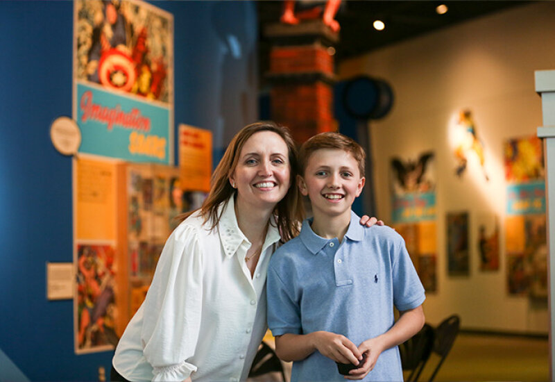 A woman and boy posing for camera