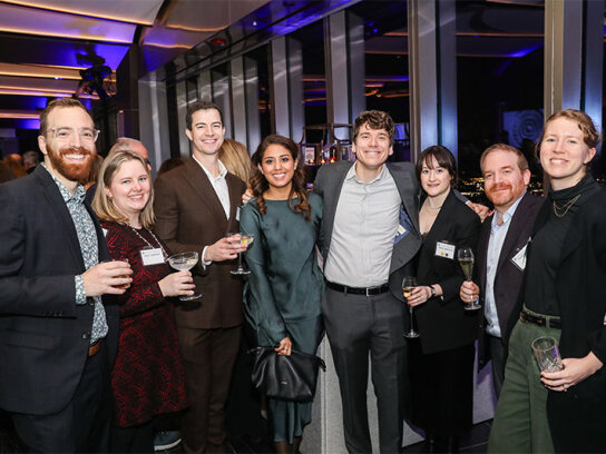 Group posing for photo at reception event
