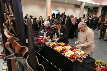 Attendees selecting food provided at the event