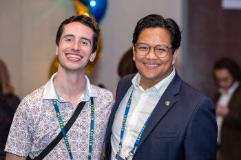 2 guys posing and smiling to the camera