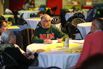 A man sitting and talking at a round table