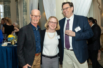 Three individuals posing for a photo.