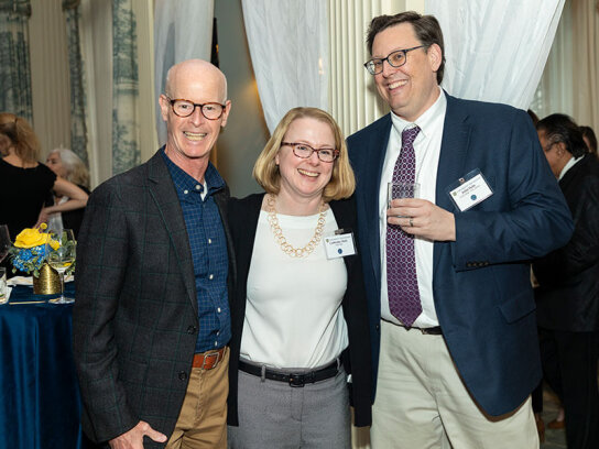 Three individuals posing for a photo.