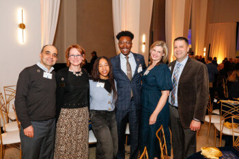 A group of attendees pose for a photo at the George Eastman Circle Annual Member Dinner.