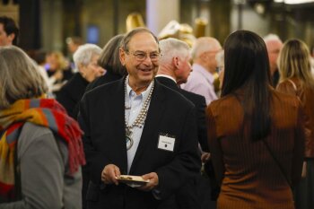 A man smiling in a crowd of people