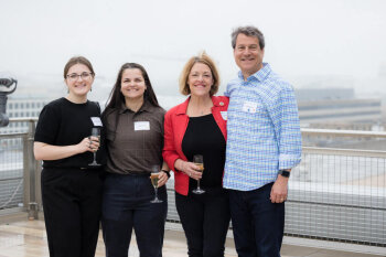 Four individuals pose for a photo at the George Eastman Circle Family Celebration, held April 30, 2023, within Washington, DC.