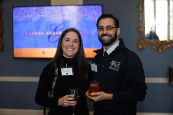 A woman and man pose for a photo at the George Eastman Circle Faculty & Staff Reception held on March 30, 2023 within Rochester New York.