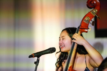 a female musician playing an instrument during the event.