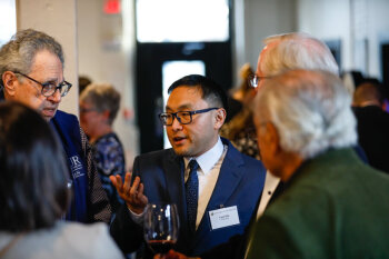 A guest engages in conversation during the George Eastman Circle Faculty & Staff Reception in Rochester, NY.