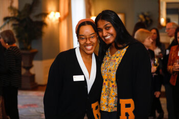 Two women pose for a photo at the George Eastman Circle Faculty & Staff Reception held on March 30, 2023 within Rochester New York.