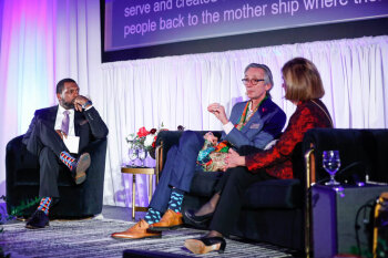 Three speakers having a conversation on stage at the George Eastman Circle Annual Member Dinner.