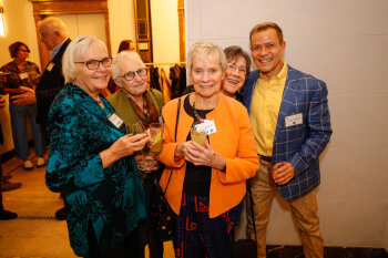 A group of attendees pose for a photo at the George Eastman Circle Annual Member Dinner.
