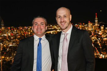Two men posing for photo wearing suit and tie
